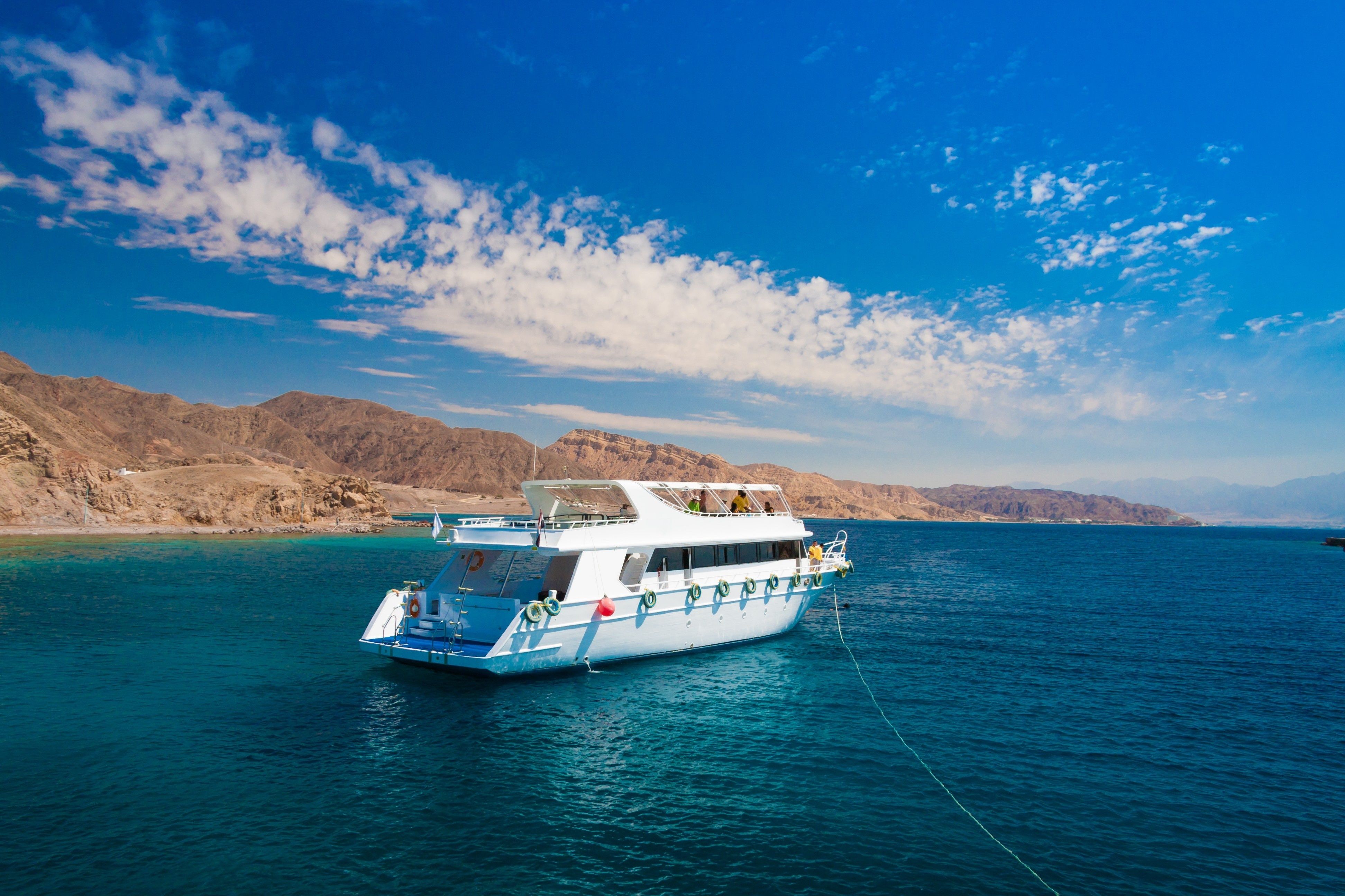 White scuba diving boat on the Red Sea in Egypt with mountain backdrop