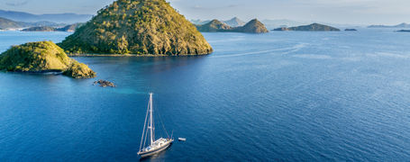 Sailing boat on blue sea with many small islands in Komodo national park in Indonesia.