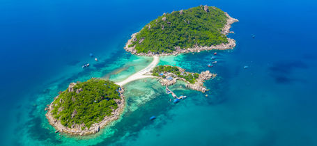 Aerial drone view of tropical Koh Nang Yuan Island surrounded by Turquoise water and white sand bays, near Koh Tao in Thailand