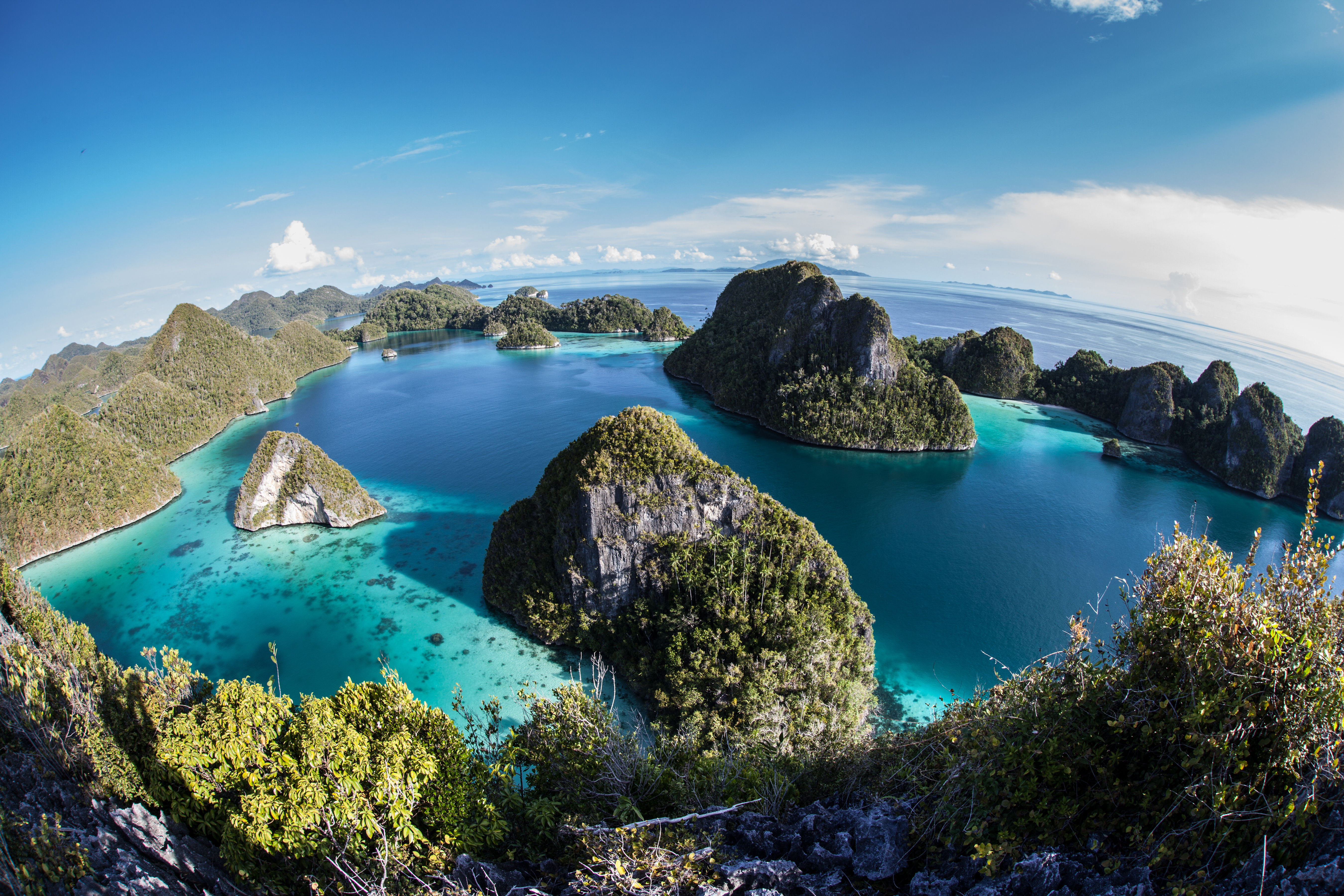 Aerial view of Indonesian archipelago, Raja Ampat jungle covered Islands in tropical seas.