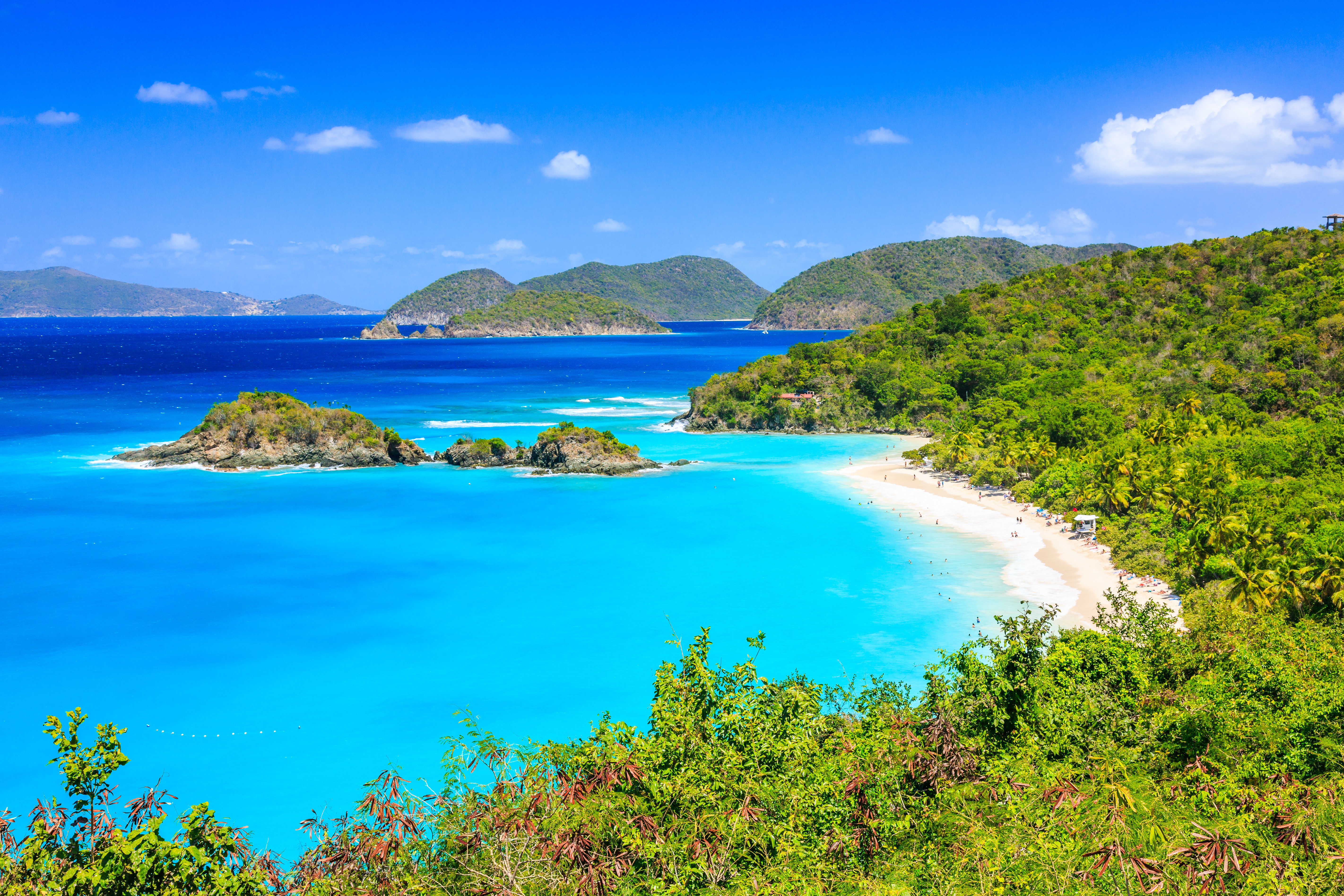 Panorama view of tropical Caribbean islands, green trees, white sand shores and turquoise waters. 