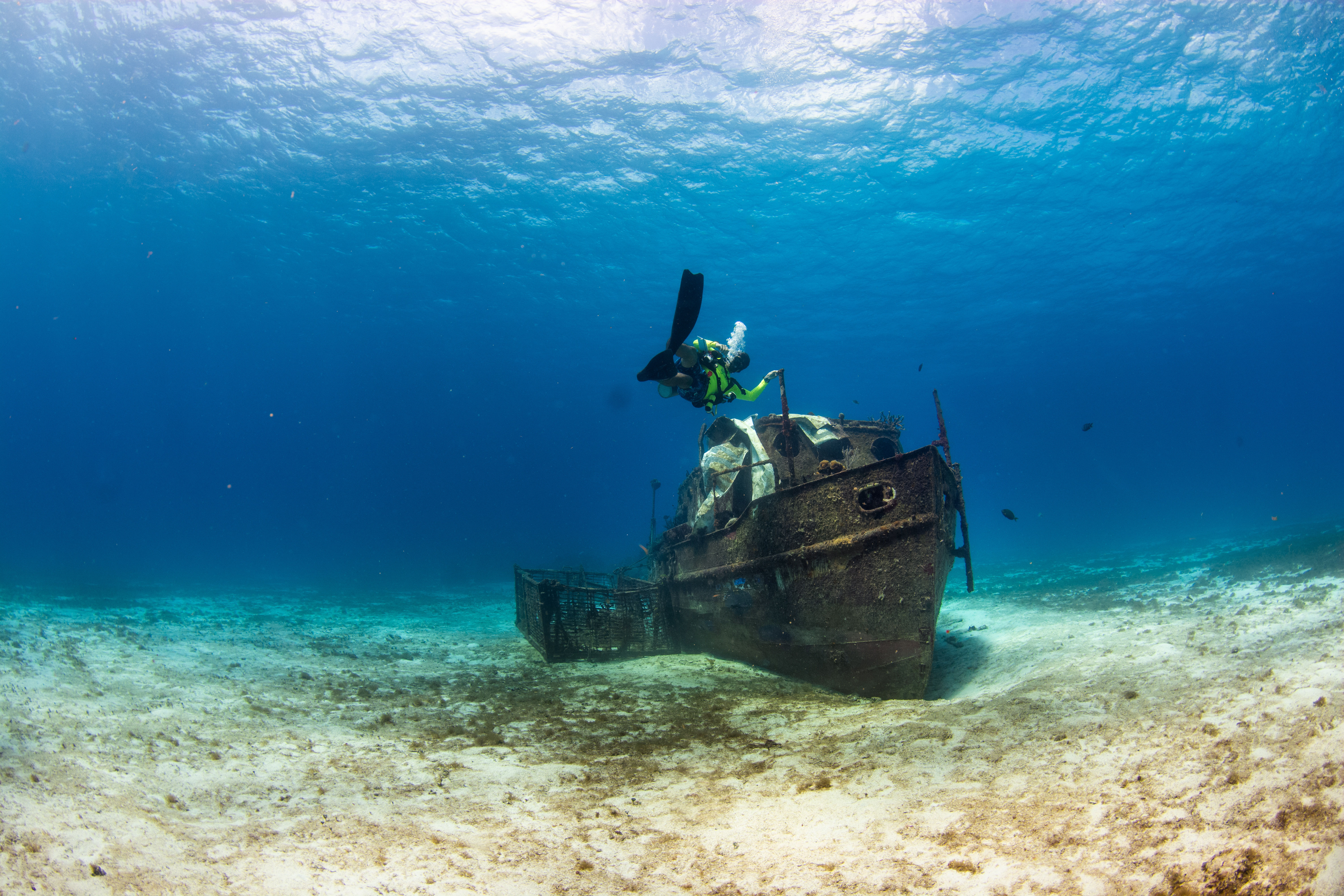 Diver next to small underwater wreck in Cozumel, Mexico.