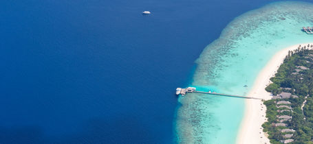 Aerial view of tropical island and resort in Raa Atoll in the Maldives.