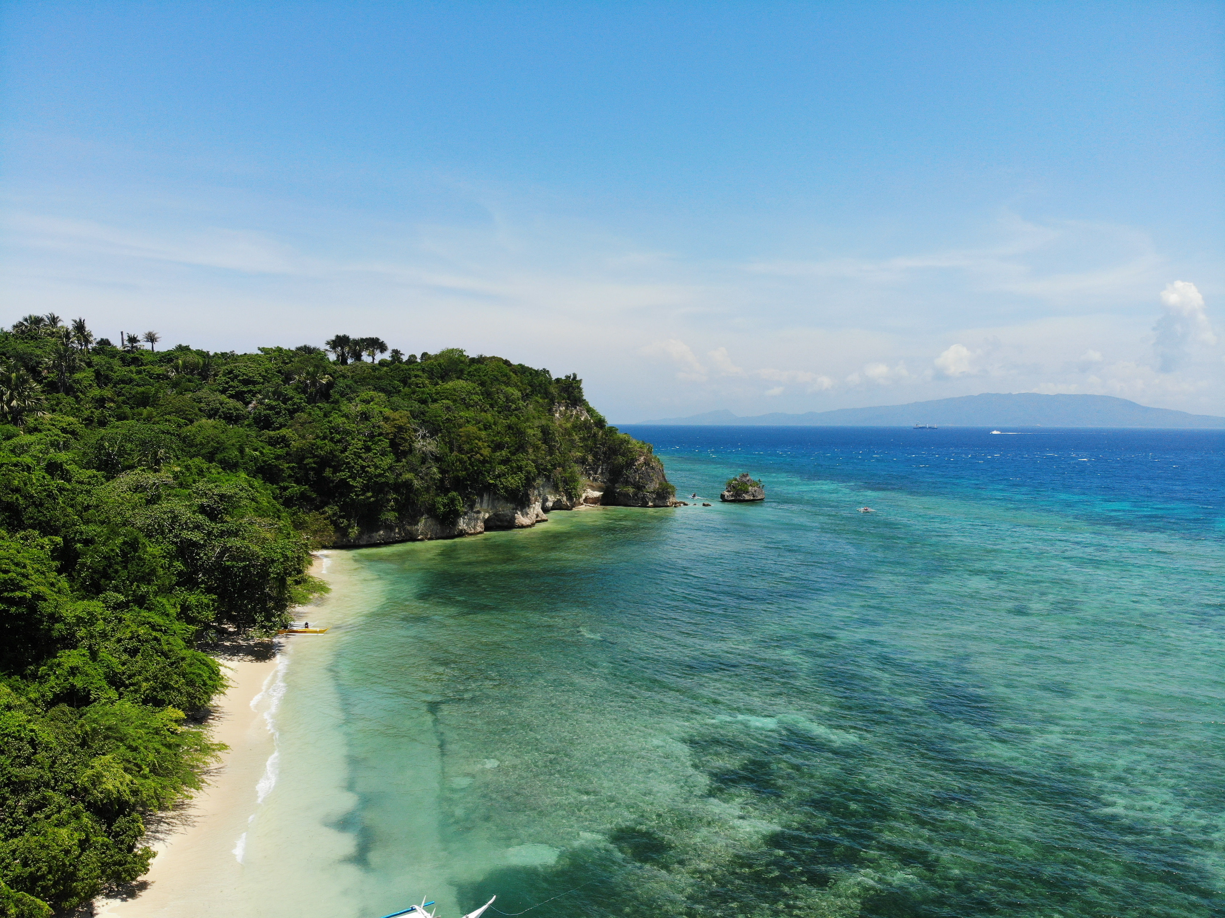 Aerial view of the tropical white sand coastline of Puerto Galera Philippines.