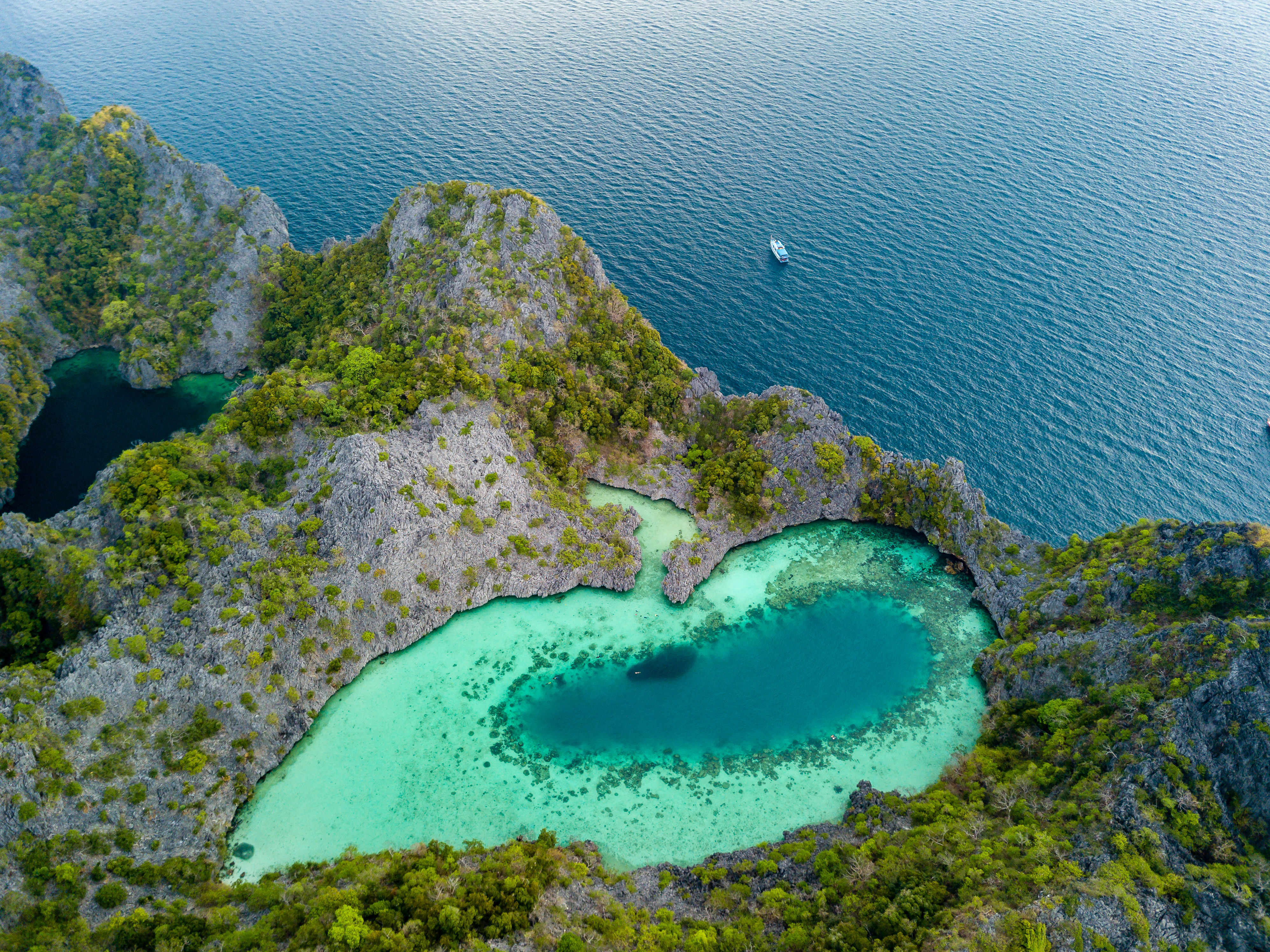Aerial drone view of a beautiful coral lagoon inside a remote tropical island in Myanmar.