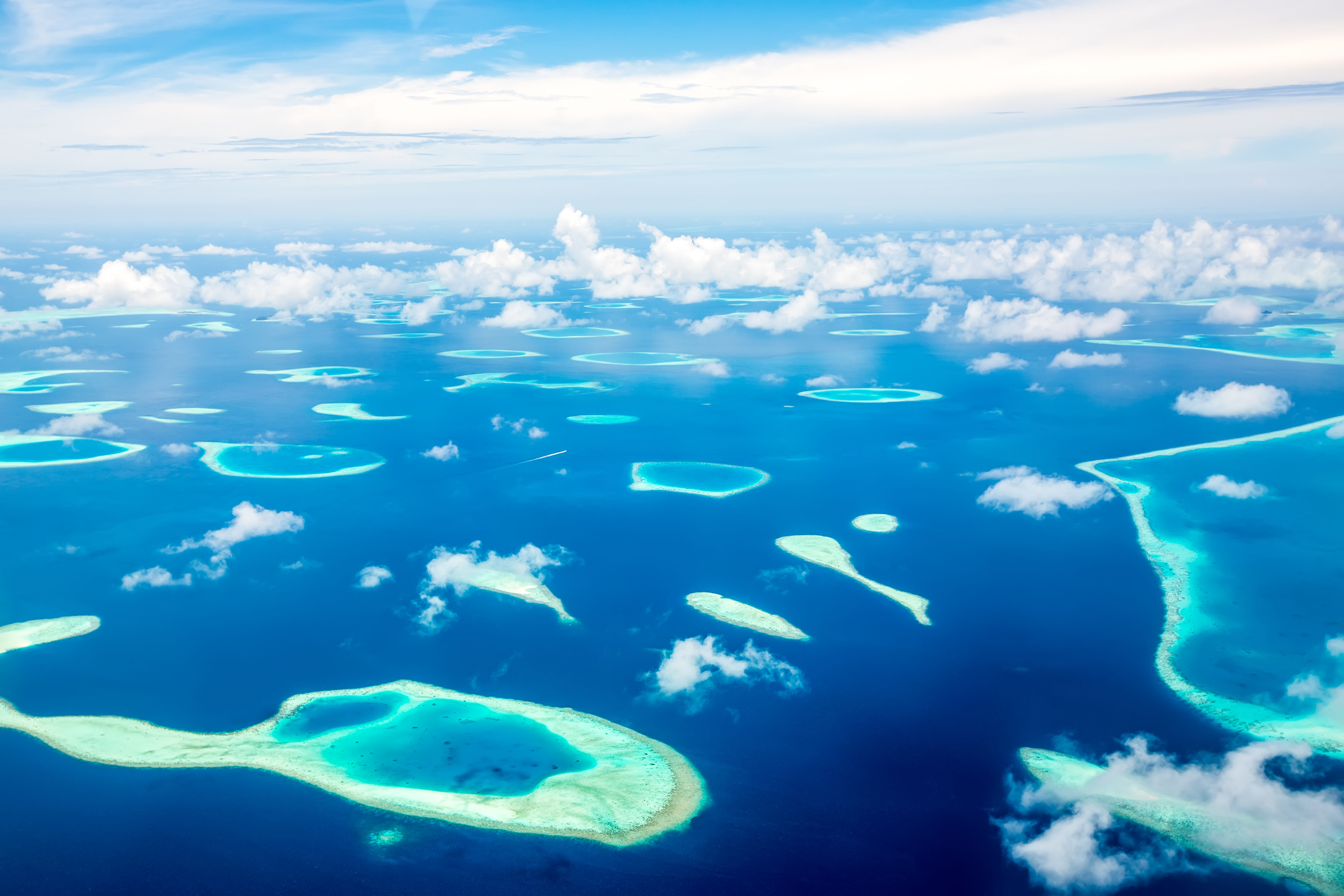 Aerial view of Maldives atoll in Indian Ocean. 